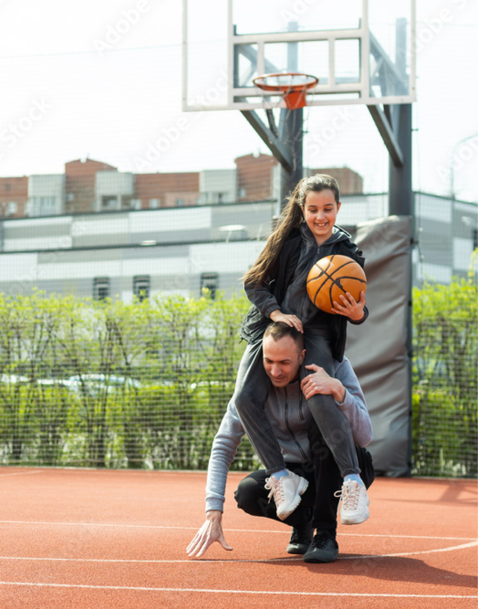 father and daughter playing outdoor basketball